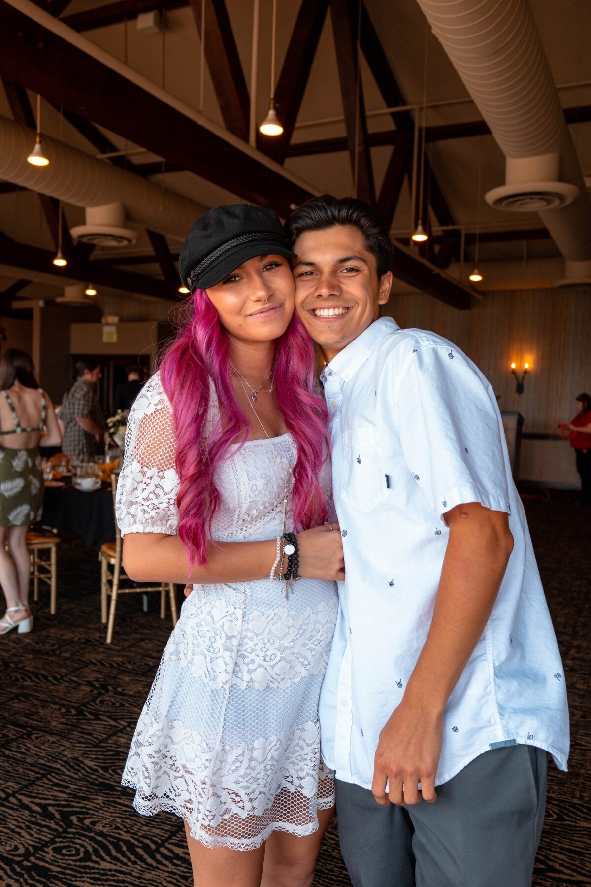 Couple smiling together at an indoor celebration