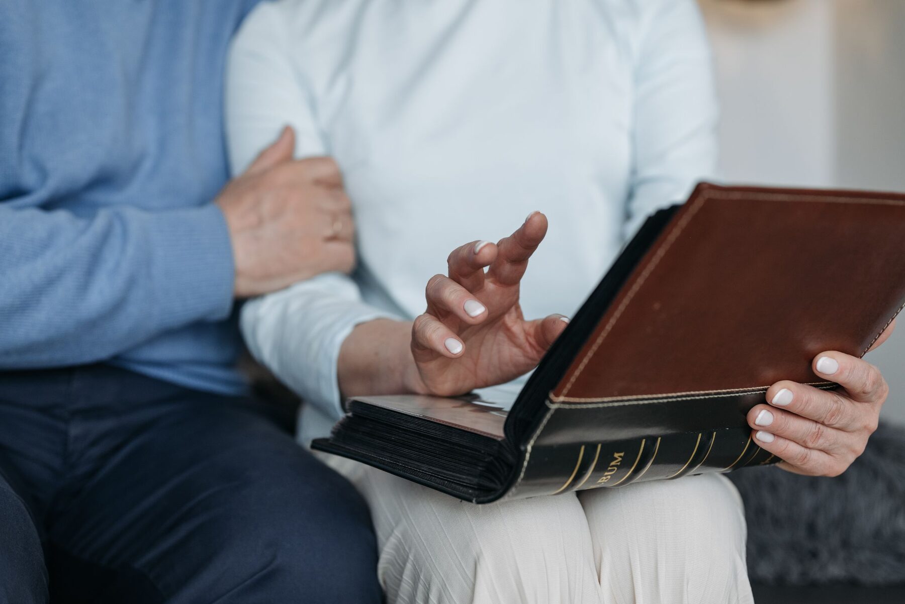 Couple turning the pages of a keepsake photo album