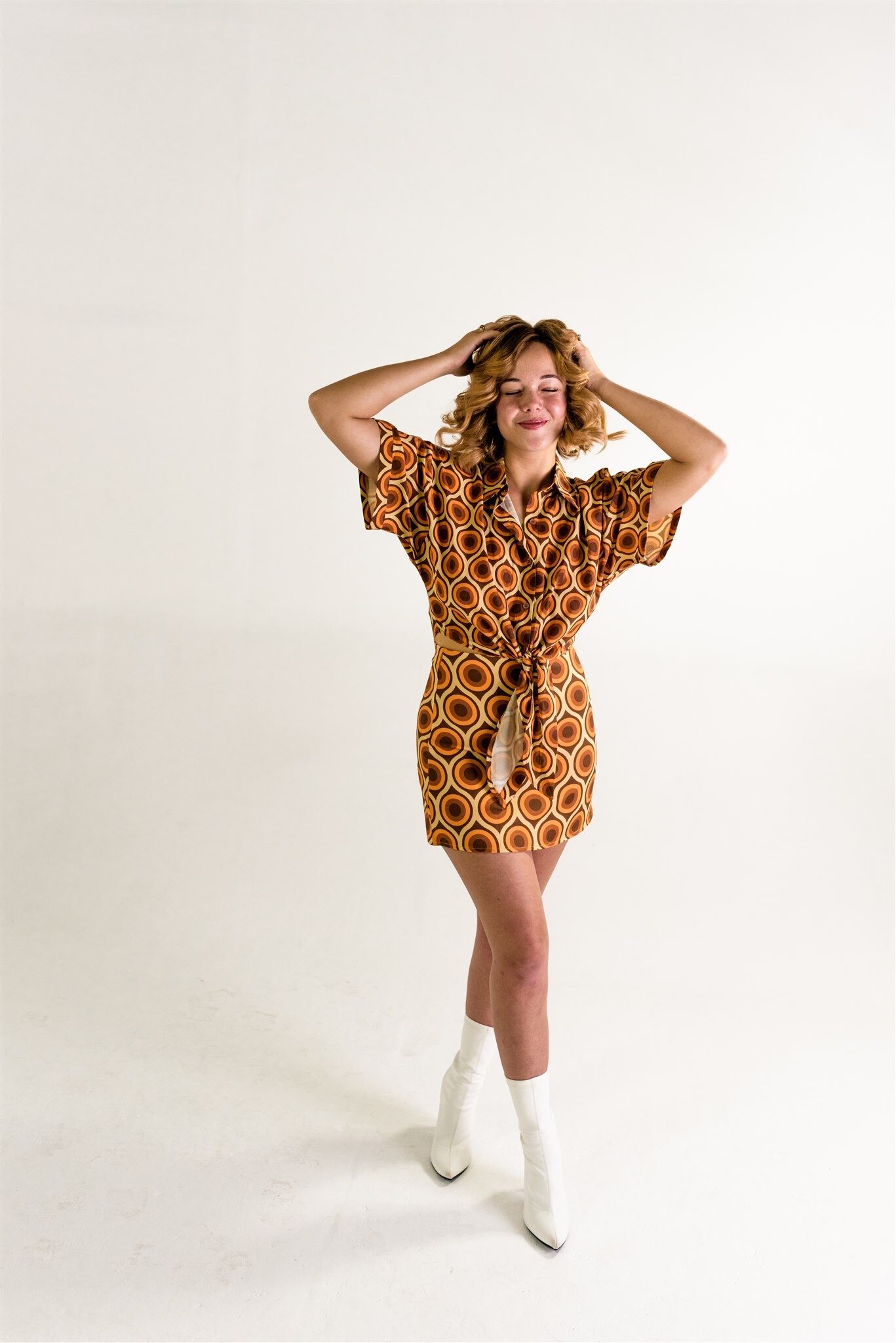 Woman posing in a retro patterned outfit during a creative portrait session